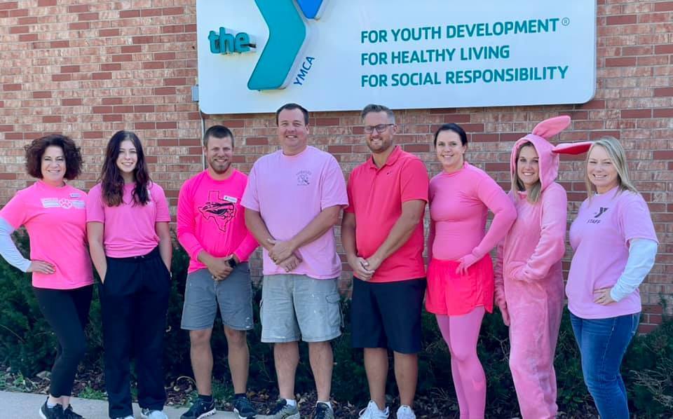 YMCA staff dressed in all pink to support our swimmers