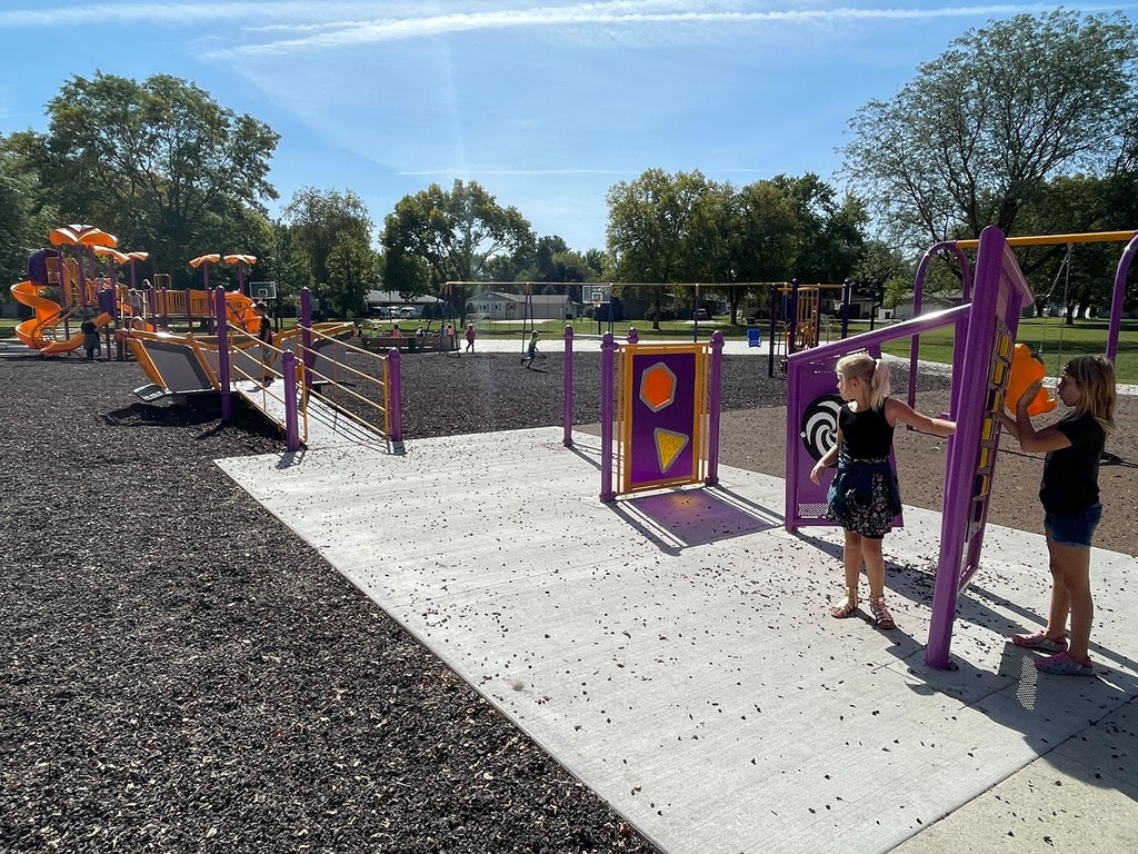 Students play on playground equipment accessible by wheelchair ramp 