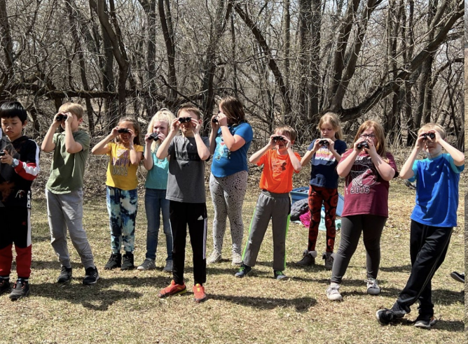 group of student using binoculars
